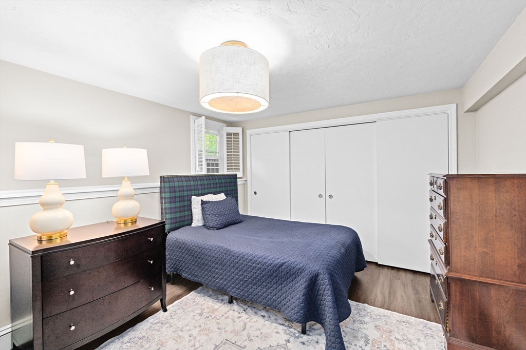 40 Brewster Road Cohasset, MA 02025 - Photo 31 of 42 a bedroom with a bed and cabinets