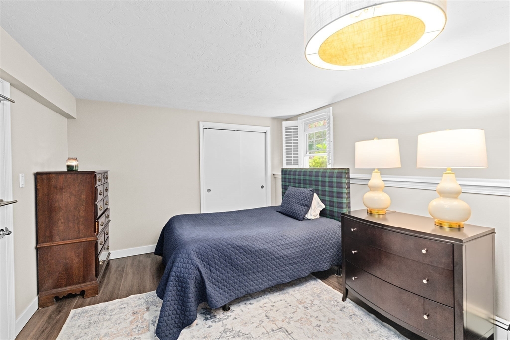 40 Brewster Road Cohasset, MA 02025 - Photo 32 of 42 a bedroom with a bed and wooden floor