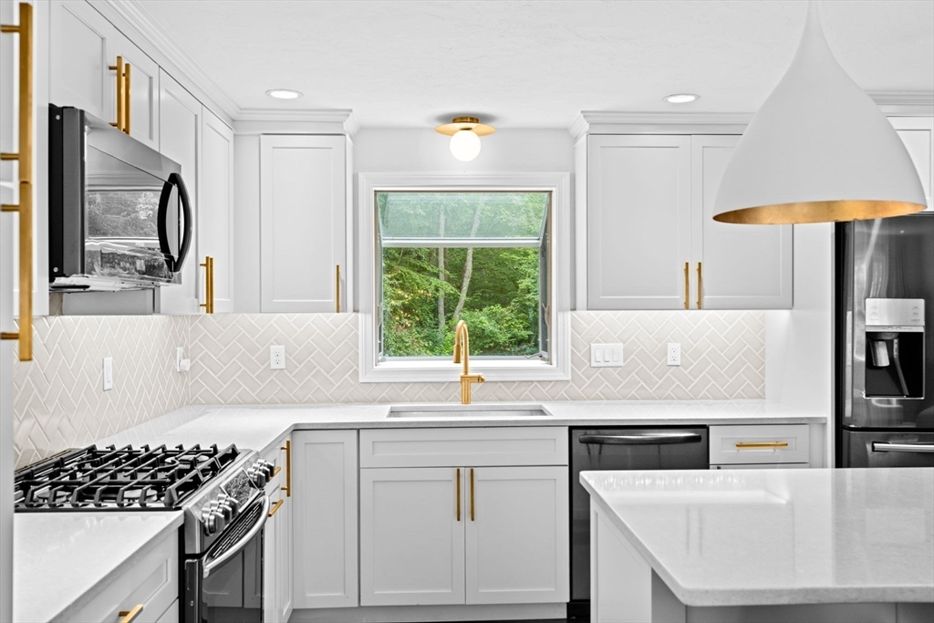 40 Brewster Road Cohasset, MA 02025 - Photo 7 of 42 a kitchen with granite countertop a sink stove and cabinets