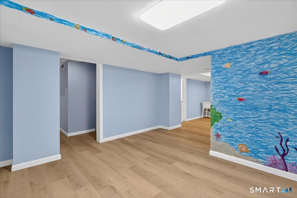 1006 King Road Cheshire, CT 06410 - Photo 29 of 40 Easy maintenance vinyl plank flooring throughout the lower level.