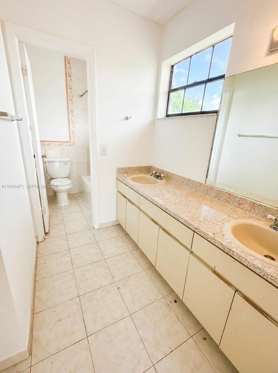 2582 West 56th Street, Unit 201 Hialeah, FL 33016 - Photo 17 of 20 a bathroom with a sink a toilet and a shower