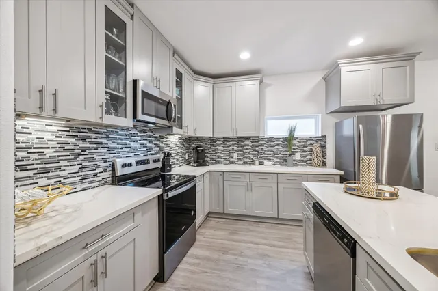a kitchen with a sink stove and refrigerator