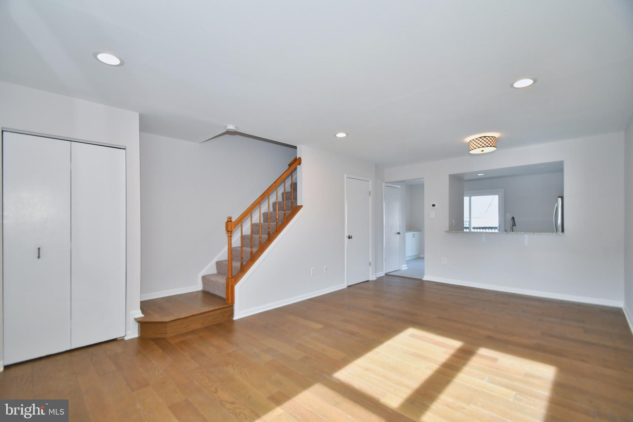 28 Pine Chip Court Baltimore, MD 21236 - Photo 12 of 32 a view of an empty room with stairs and a window
