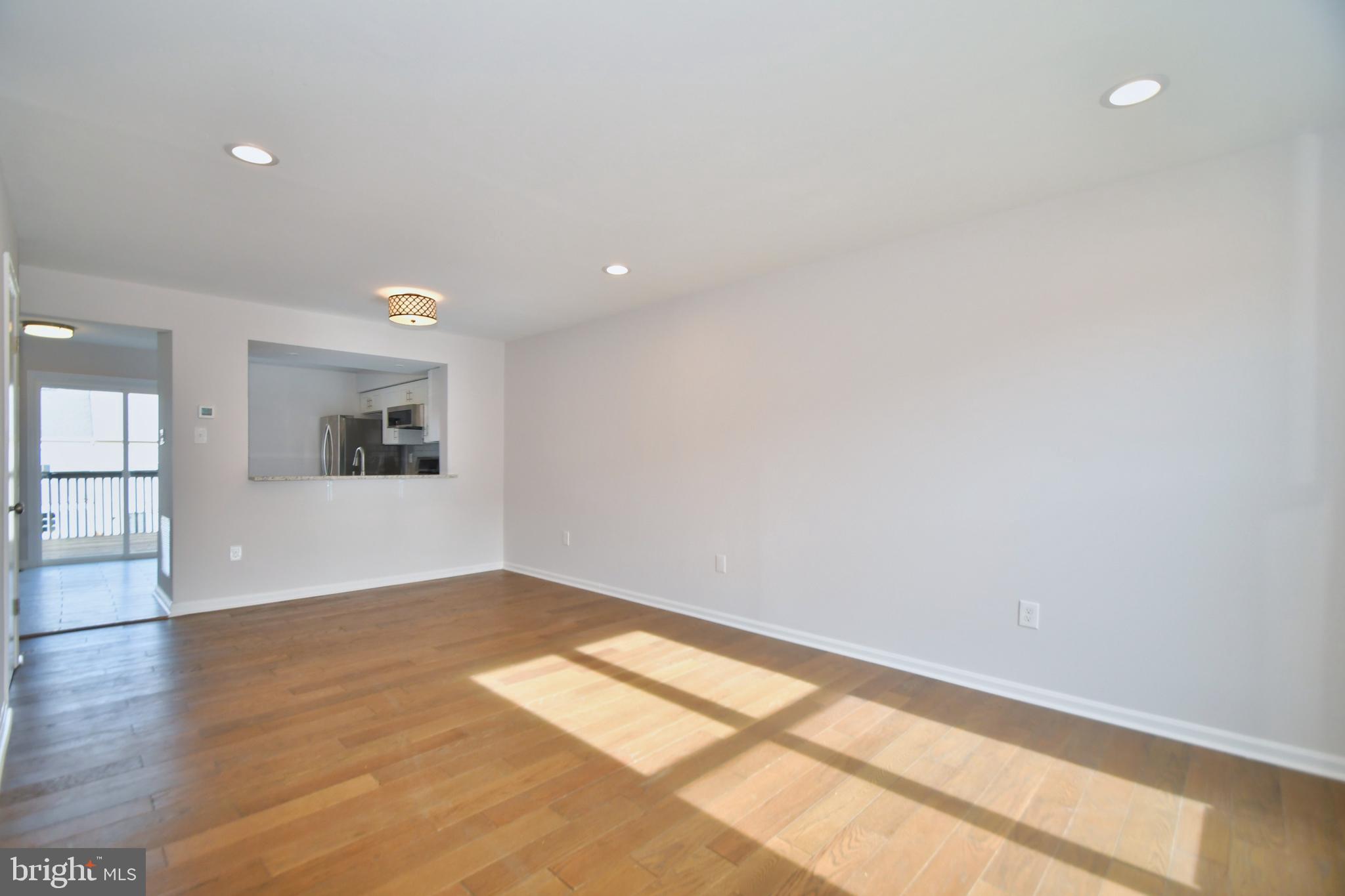 28 Pine Chip Court Baltimore, MD 21236 - Photo 14 of 32 wooden floor in an empty room with a window