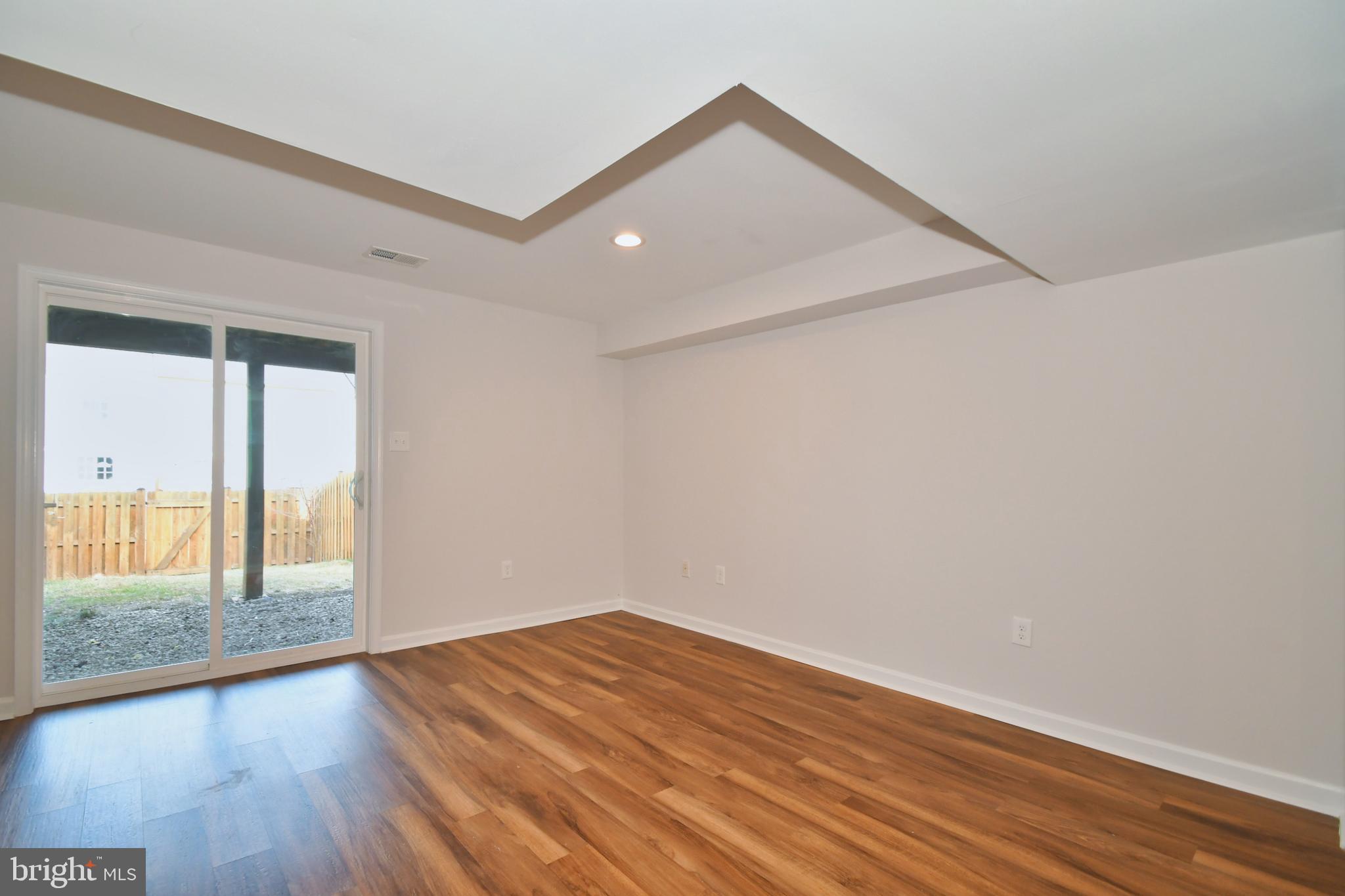28 Pine Chip Court Baltimore, MD 21236 - Photo 29 of 32 a view of empty room with wooden floor and fan
