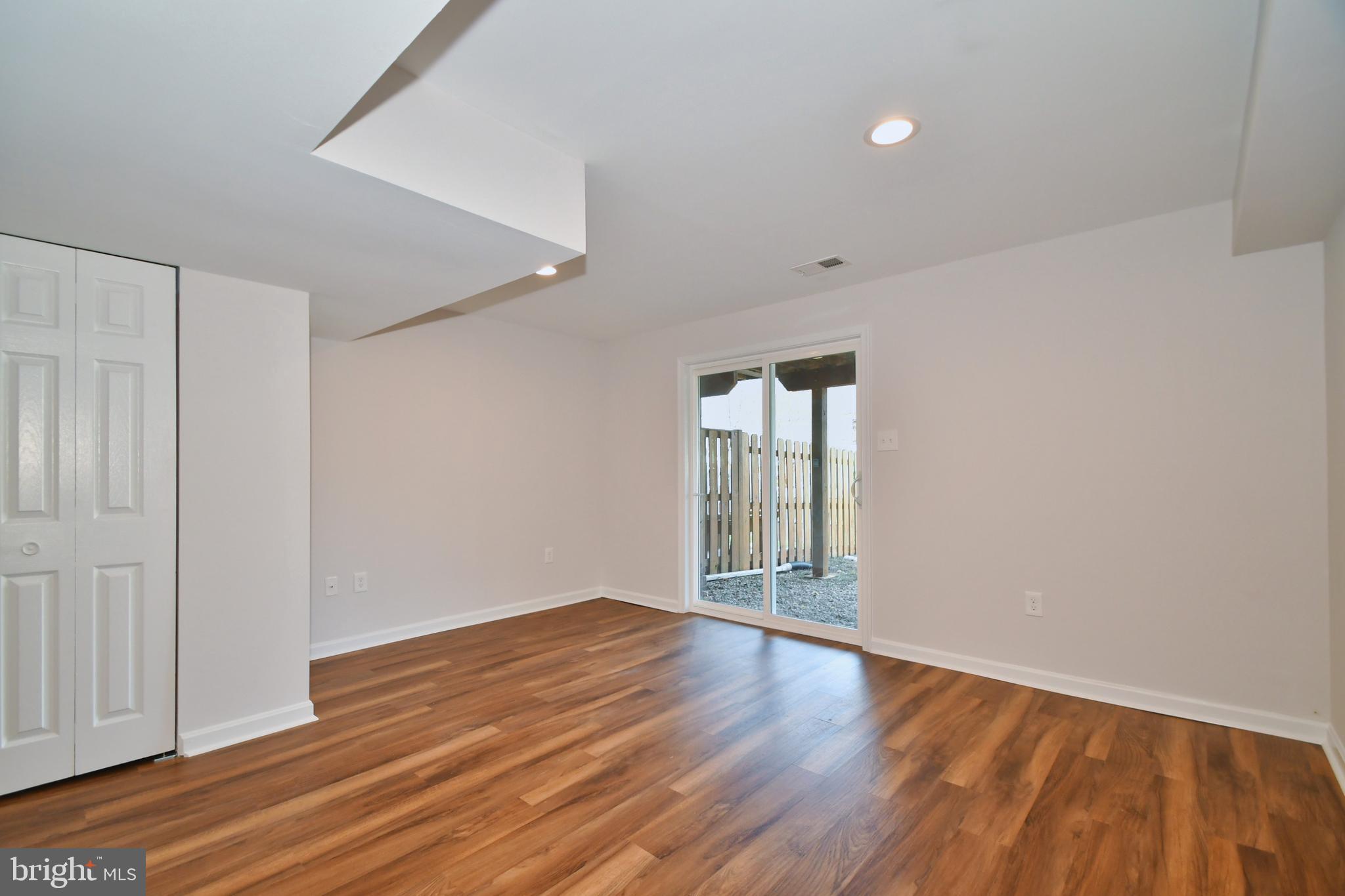 28 Pine Chip Court Baltimore, MD 21236 - Photo 30 of 32 wooden floor in an empty room with a window