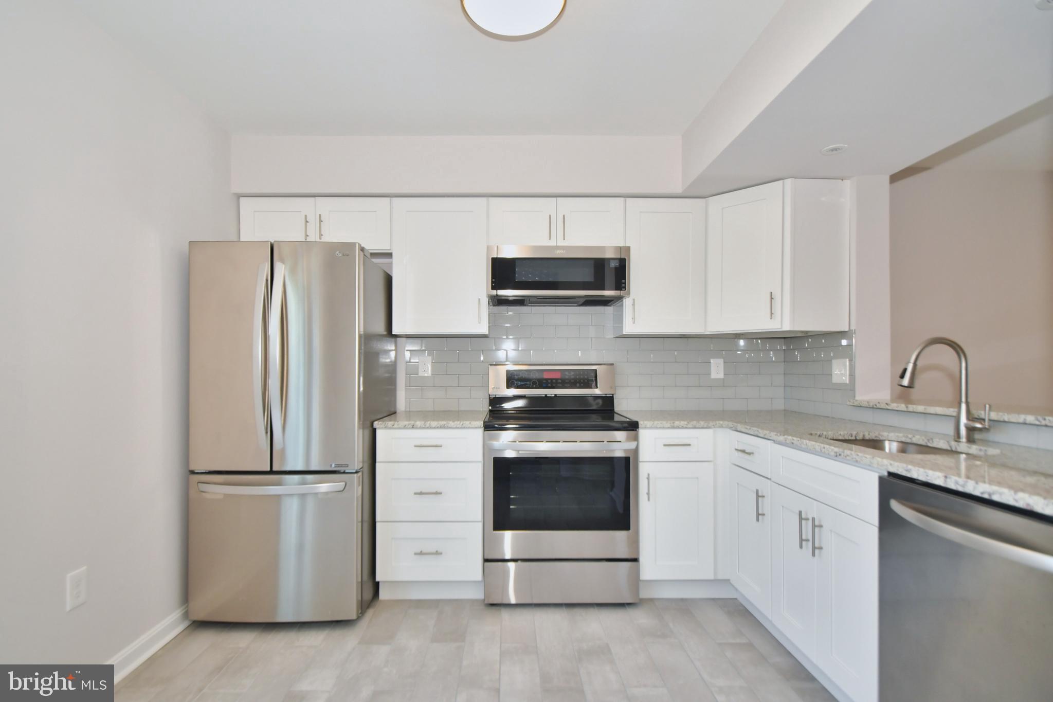 28 Pine Chip Court Baltimore, MD 21236 - Photo 9 of 32 a kitchen with stainless steel appliances granite countertop a refrigerator stove a sink and dishwasher