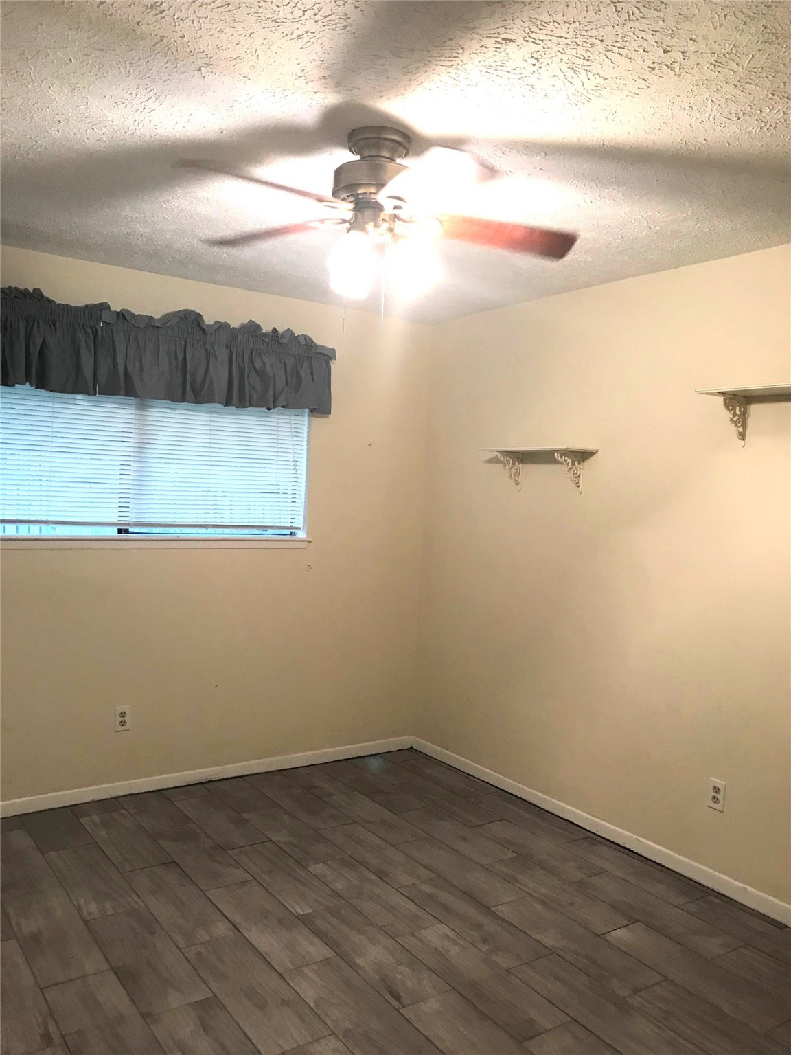 2847 Field Line Drive Sugar Land, TX 77479 - Photo 6 of 13 en empty room with wooden floor and fan