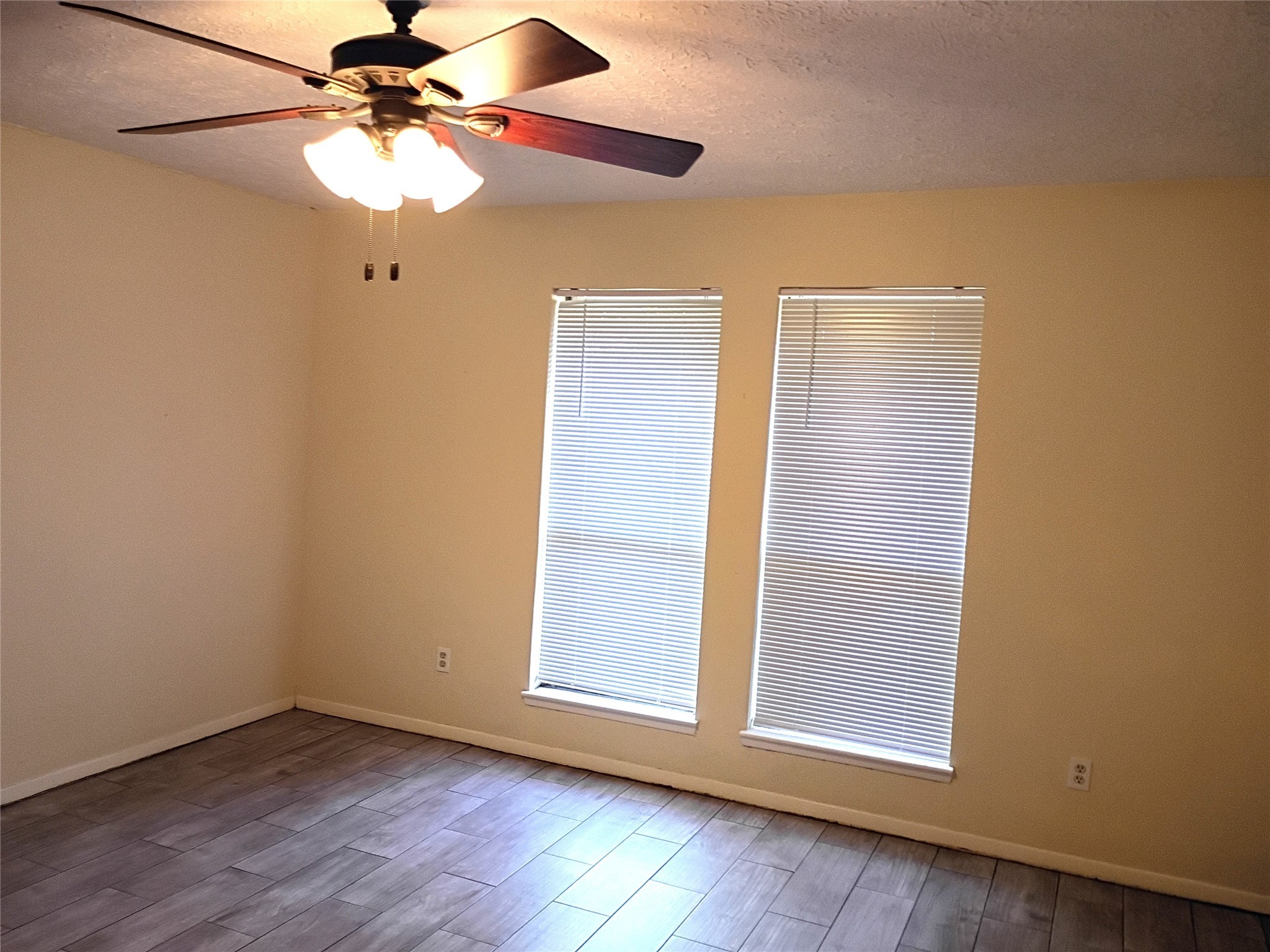 2847 Field Line Drive Sugar Land, TX 77479 - Photo 7 of 13 an empty room with wooden floor fan and windows
