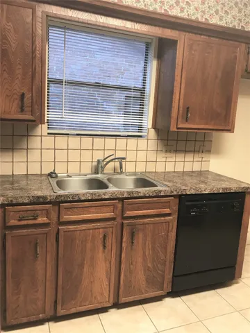a kitchen with a stove and cabinets