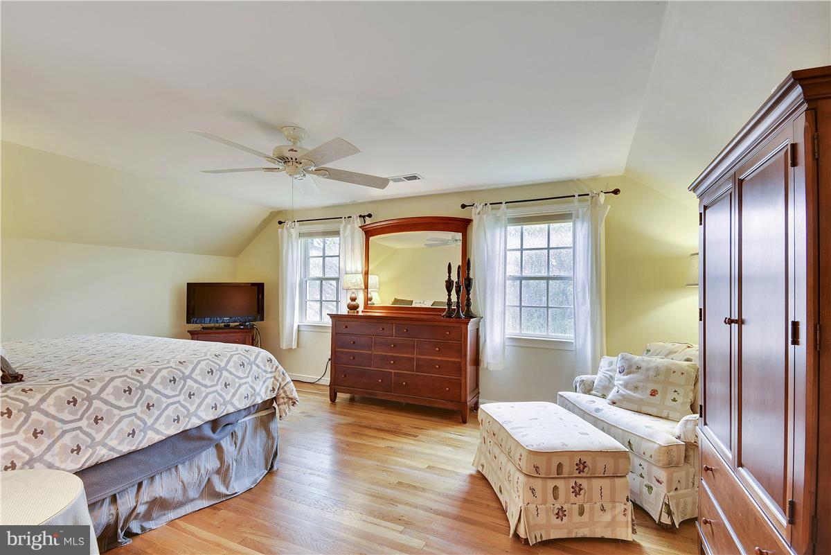 5 Cold Spring Court Potomac, MD 20854 - Photo 12 of 30 a bedroom with a bed and wooden floor