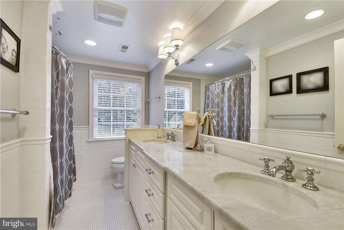 5 Cold Spring Court Potomac, MD 20854 - Photo 18 of 30 a spacious bathroom with a granite countertop sink a toilet a large mirror and shower