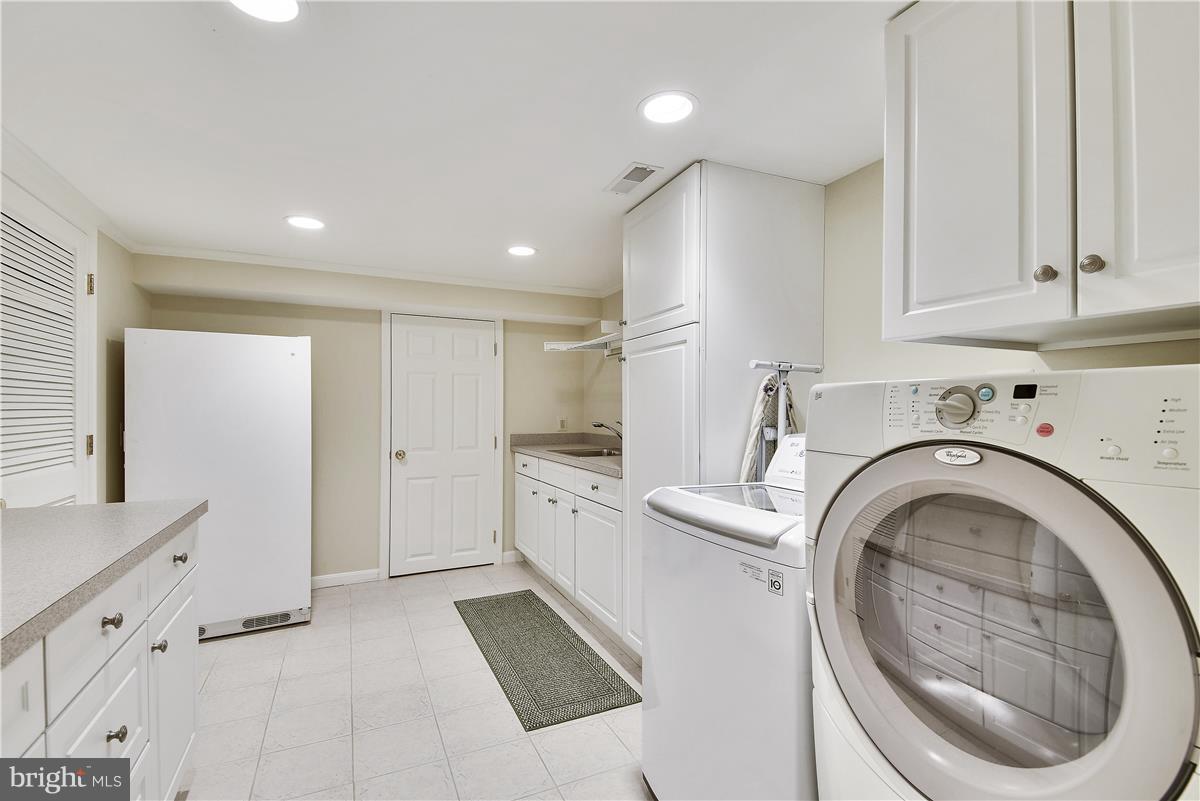 5 Cold Spring Court Potomac, MD 20854 - Photo 22 of 30 a large white kitchen with cabinets and washer dryer