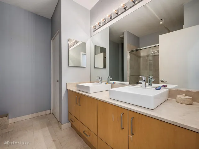 a view of bathroom with a sink and mirror