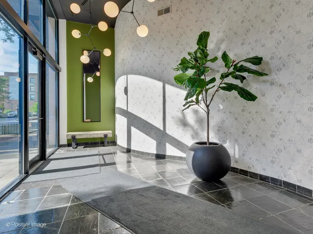 a front view of a building with large trees