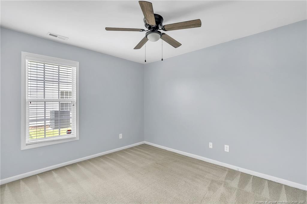 1948 Yellowbrick Road Fayetteville, NC 28314 - Photo 13 of 22 an empty room with a window and a fan