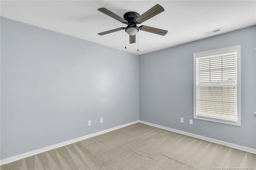 1948 Yellowbrick Road Fayetteville, NC 28314 - Photo 16 of 22 an empty room with a window and a fan