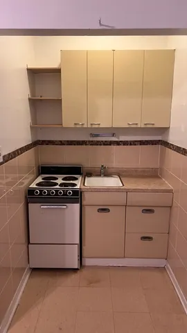a kitchen with a stove and a cabinet