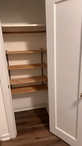 a view of walk in closet with empty racks