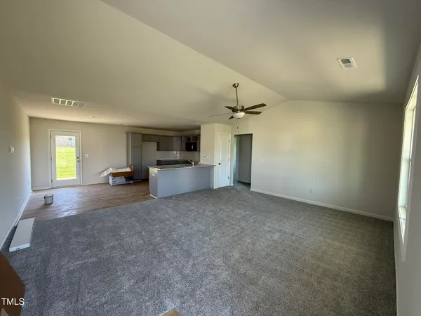 a view of empty room with fireplace and windows