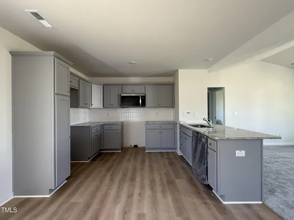 a kitchen with stainless steel appliances granite countertop a stove and a sink
