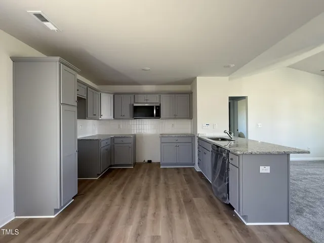 a kitchen with stainless steel appliances granite countertop a stove and a sink