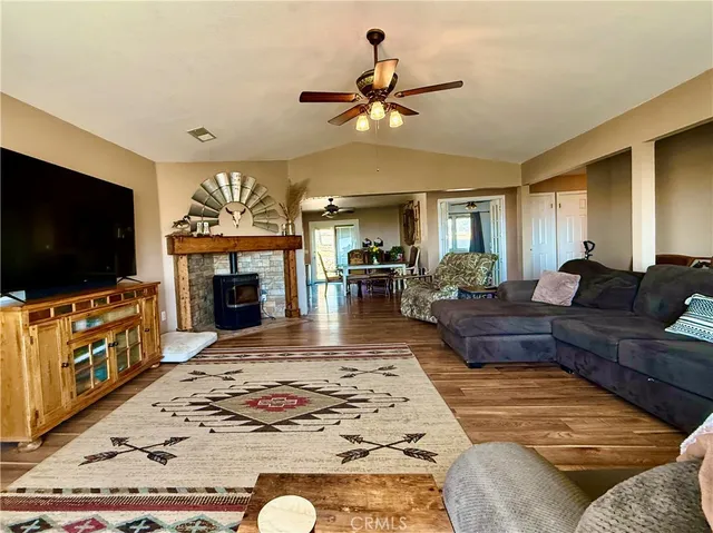 a living room with fireplace furniture and a flat screen tv