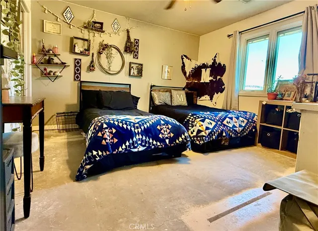 a bedroom with two beds and a large window