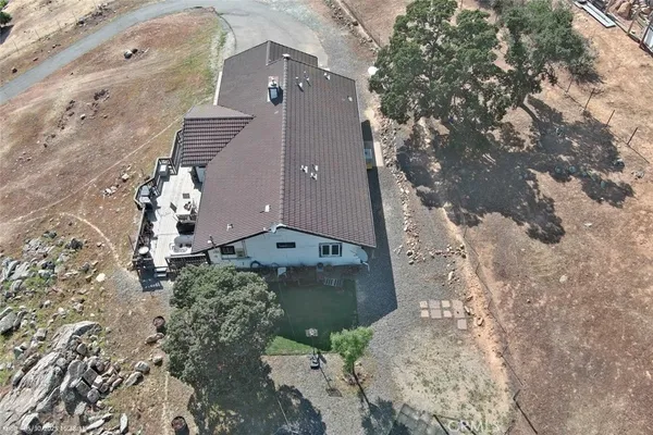 an aerial view of a house with a yard