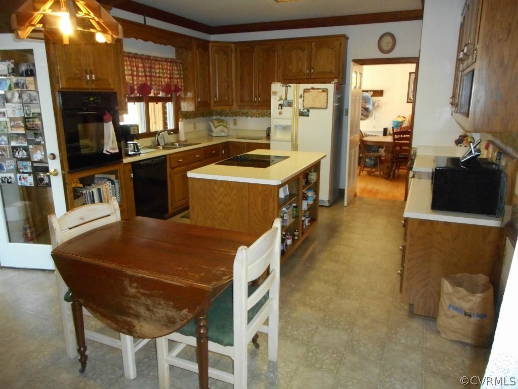 2989 The Falls Road Crewe, VA 23930 - Photo 7 of 17 a kitchen with stainless steel appliances kitchen island granite countertop a refrigerator a stove and a sink with wooden floor