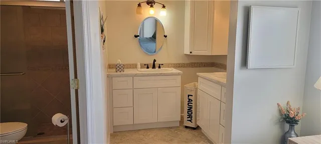 a bathroom with a toilet sink and mirror