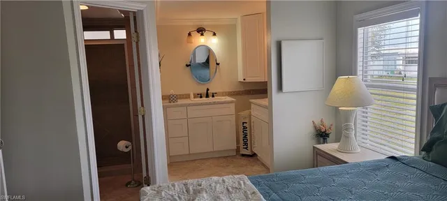 a en suite bathroom with a sink a mirror and shower