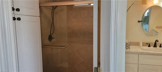 a bathroom with a shower and a sink