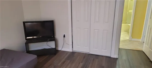 a living room with a chair and a flat screen tv