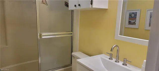 a bathroom with a sink and mirror