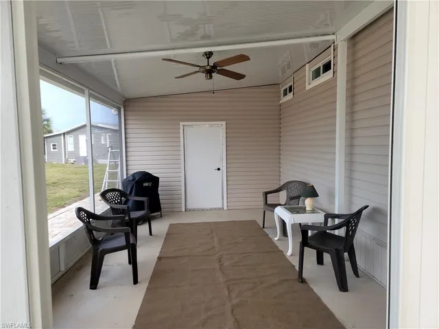 a living room with furniture and a piano