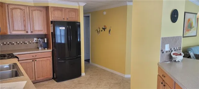 a kitchen with a refrigerator and cabinets