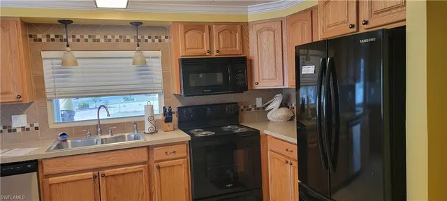 a kitchen with stainless steel appliances granite countertop a refrigerator and a sink