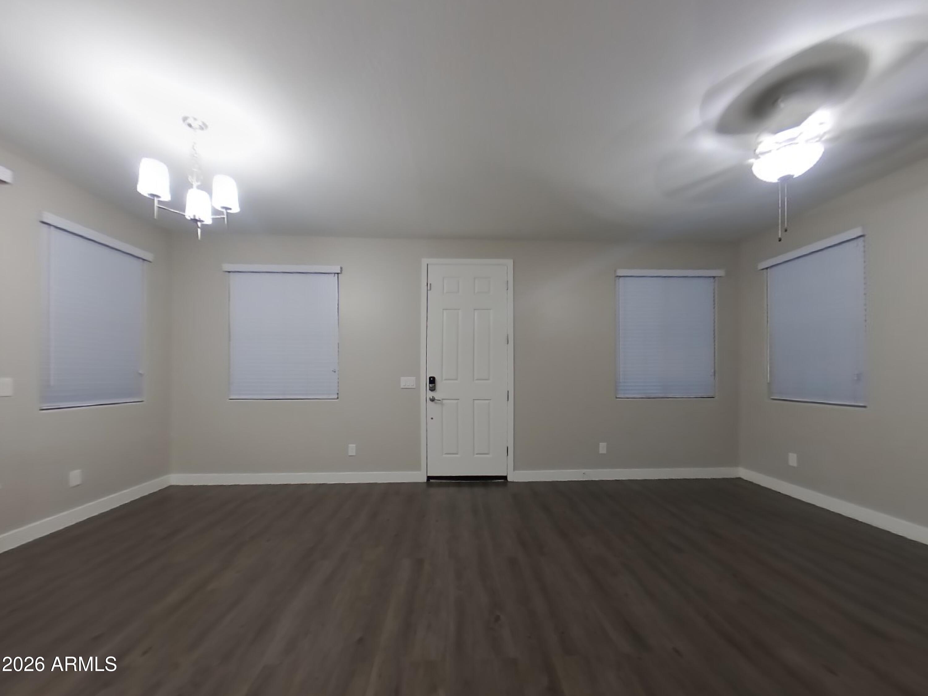 2929 North 28th Street, Unit 9 Phoenix, AZ 85016 - Photo 3 of 16 an empty room with wooden floor and windows