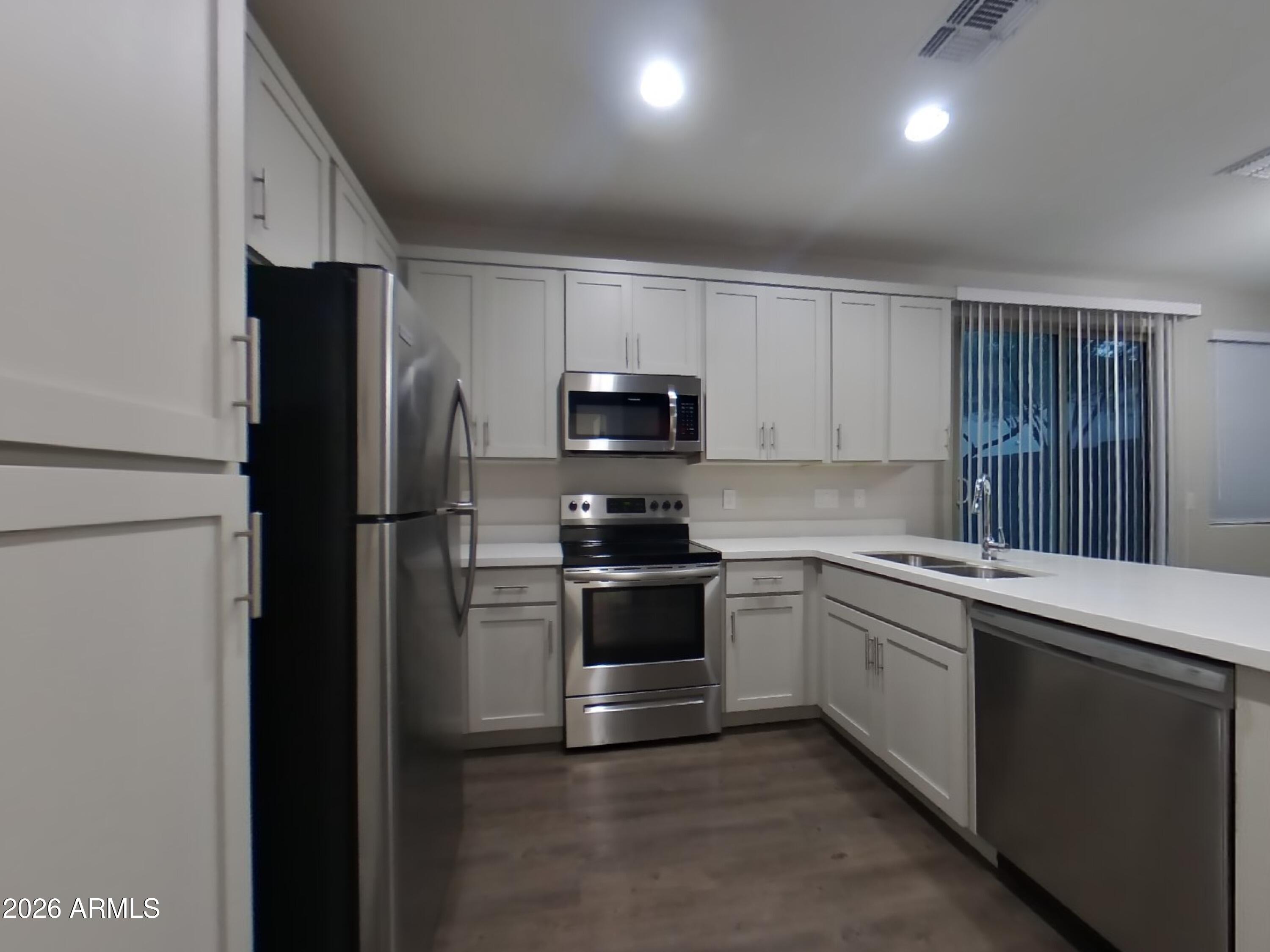 2929 North 28th Street, Unit 9 Phoenix, AZ 85016 - Photo 5 of 16 a kitchen with a sink and stainless steel appliances