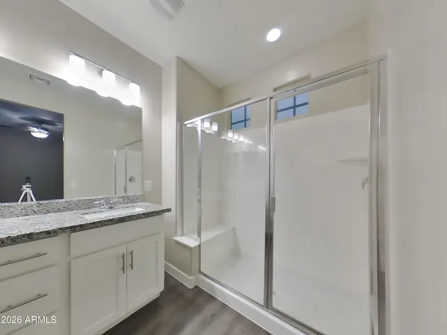 a bathroom with a granite countertop sink mirror and double