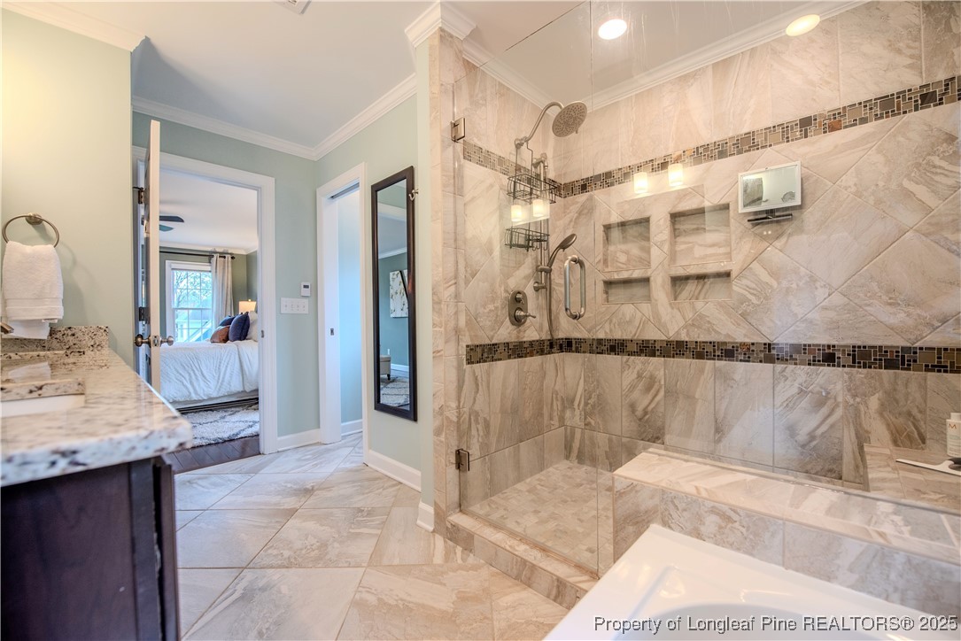 218 Waterville Street Raleigh, NC 27603 - Photo 26 of 49 a bathroom with a granite countertop sink a mirror and a shower