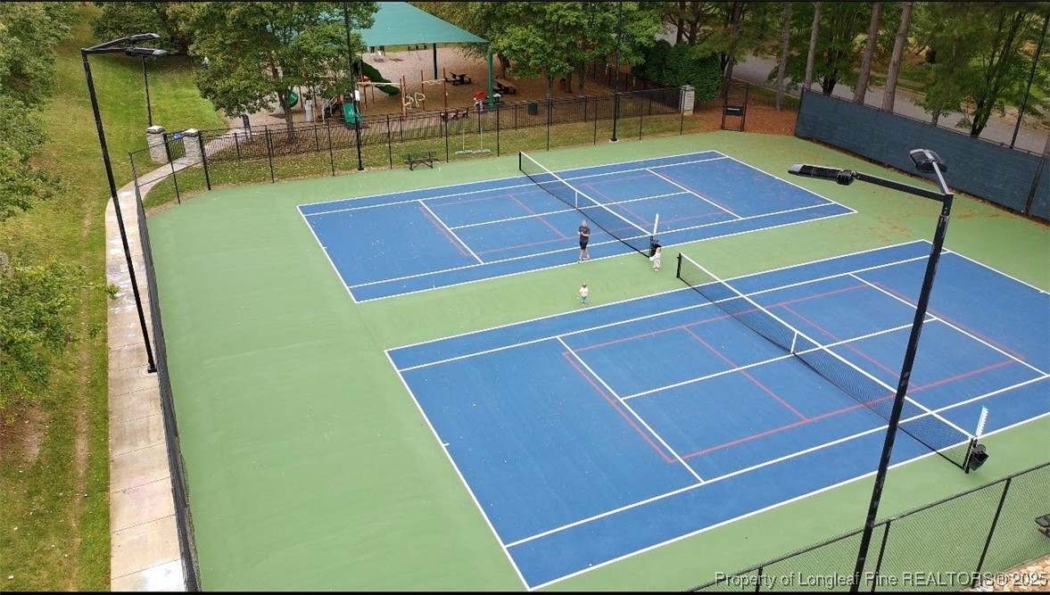 218 Waterville Street Raleigh, NC 27603 - Photo 45 of 49 a view of a tennis ground with large trees