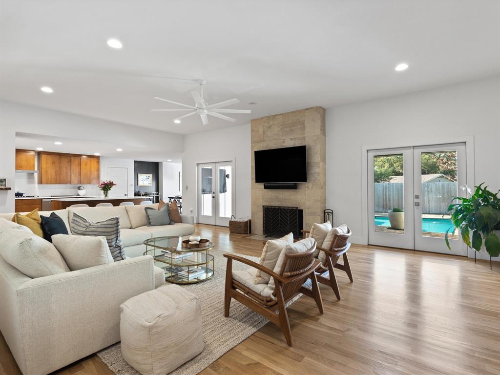 6931 Meadow Road Dallas, TX 75230 - Photo 1 of 1 a living room with furniture a fireplace and a flat screen tv