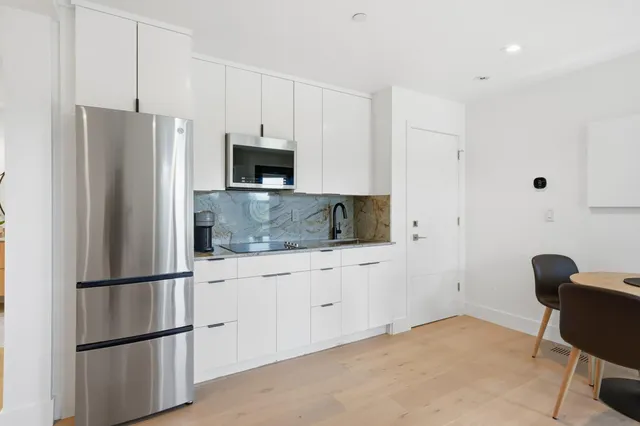 a kitchen with stainless steel appliances a refrigerator stove microwave and sink