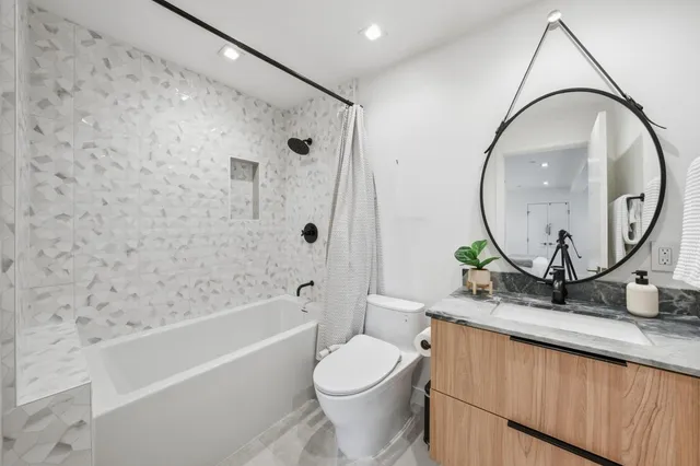 a bathroom with a sink a toilet and a mirror