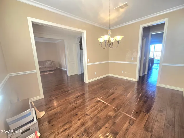 a bed sitting in a spacious bedroom next to a window
