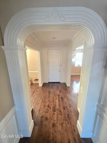 a living room with stainless steel appliances furniture and a view of kitchen
