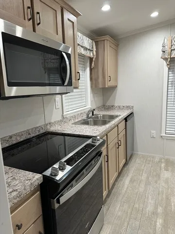 a kitchen with a stove microwave and sink