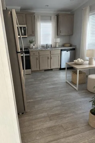 a kitchen with granite countertop a refrigerator stove and sink